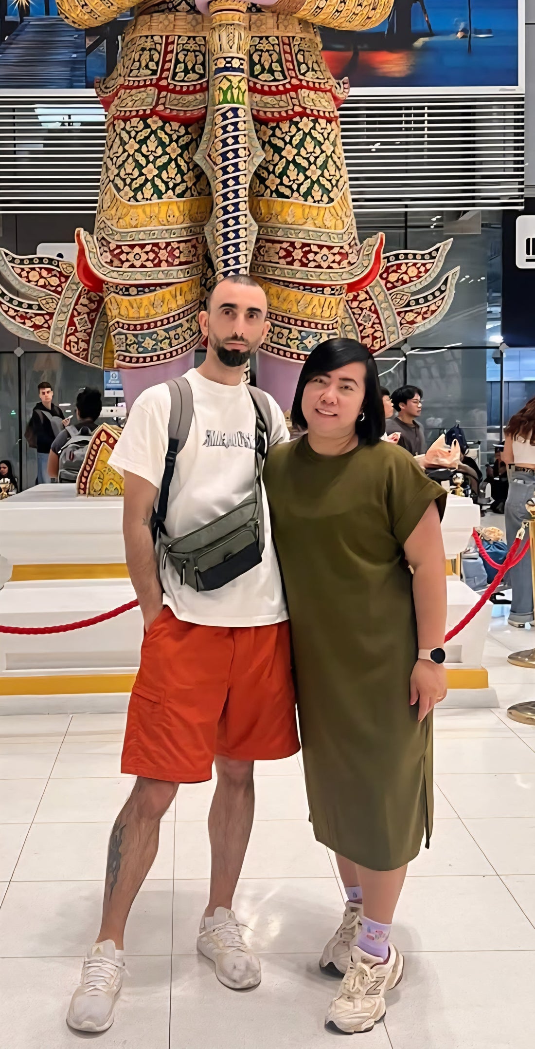The founders of BKKFinds smiling and standing together outdoors in a bustling city street.